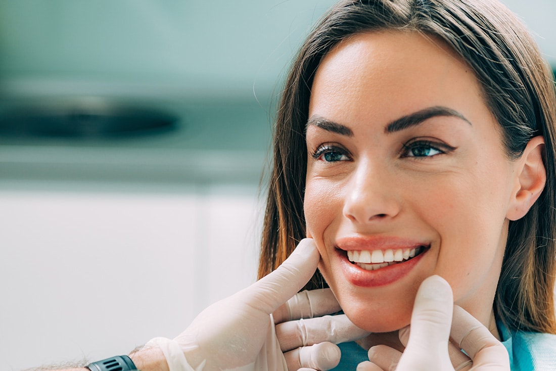 Young smiling woman with beautifiul teeth, having a dental inspection