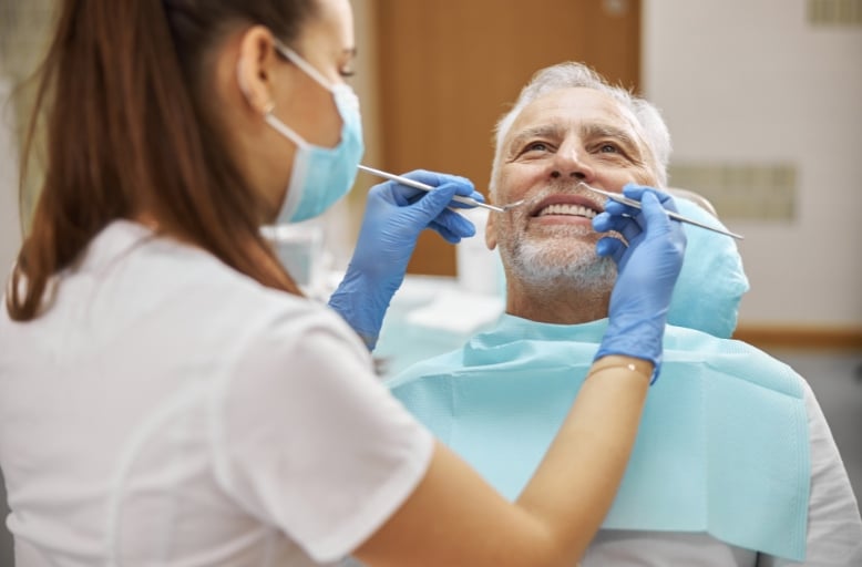 Dental cleaning vs deep cleaning South Austin showing patient getting professional teeth cleaning treatment