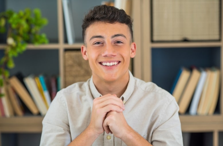 Young man with a bright healthy smile after teeth whitening in South Austin TX