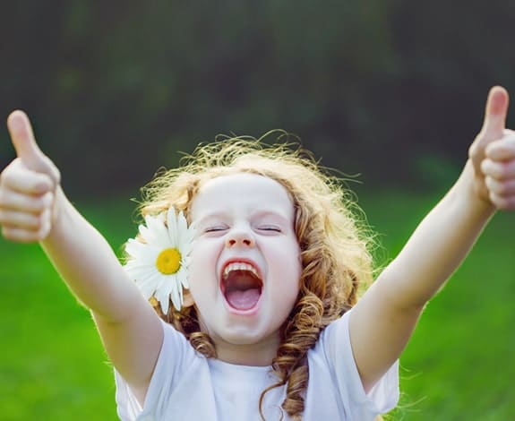 Happy child showing confidence after visiting a children’s dentist in Austin