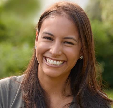 Woman showing straight teeth after Invisalign treatment in South Austin dental clinic