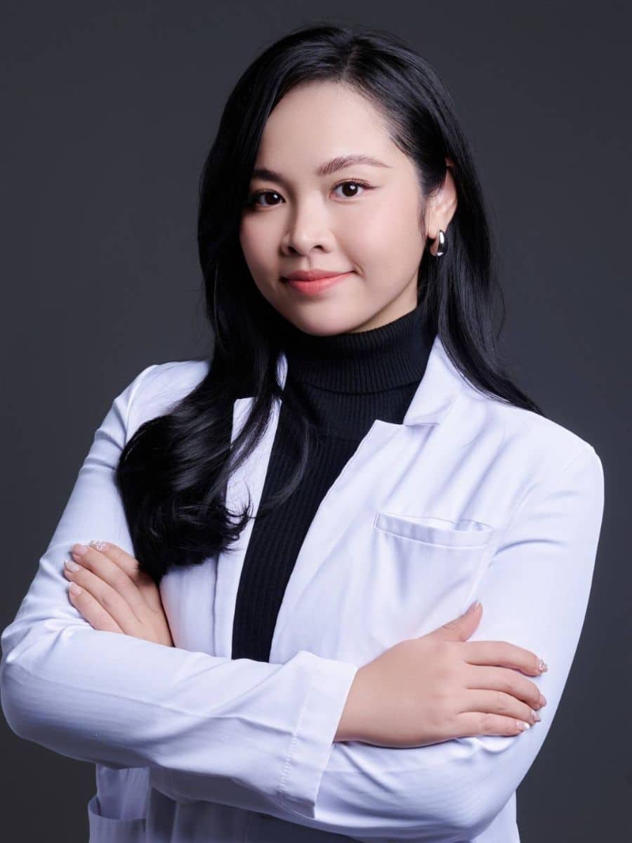Professional dental care provider portrait in South Austin wearing a white coat in a modern dental practice setting.